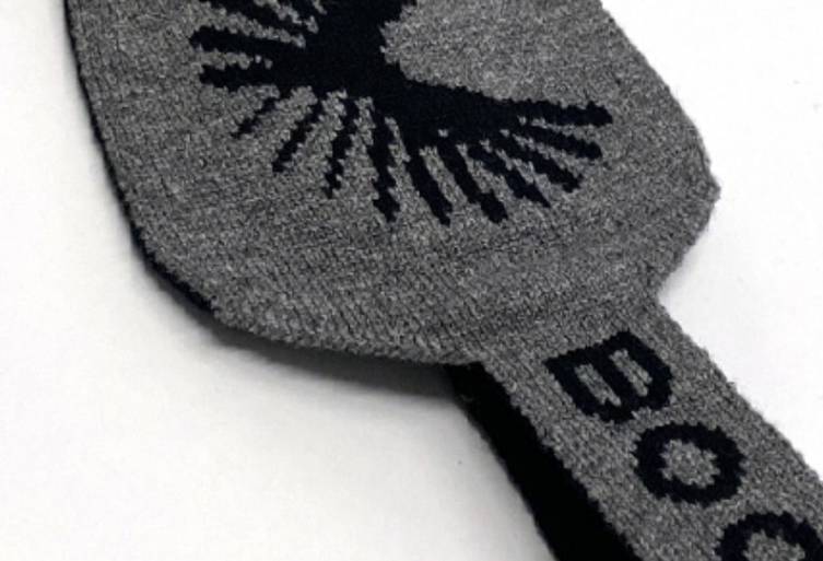 Jacquard knit logo graphic on a grey and black scarf